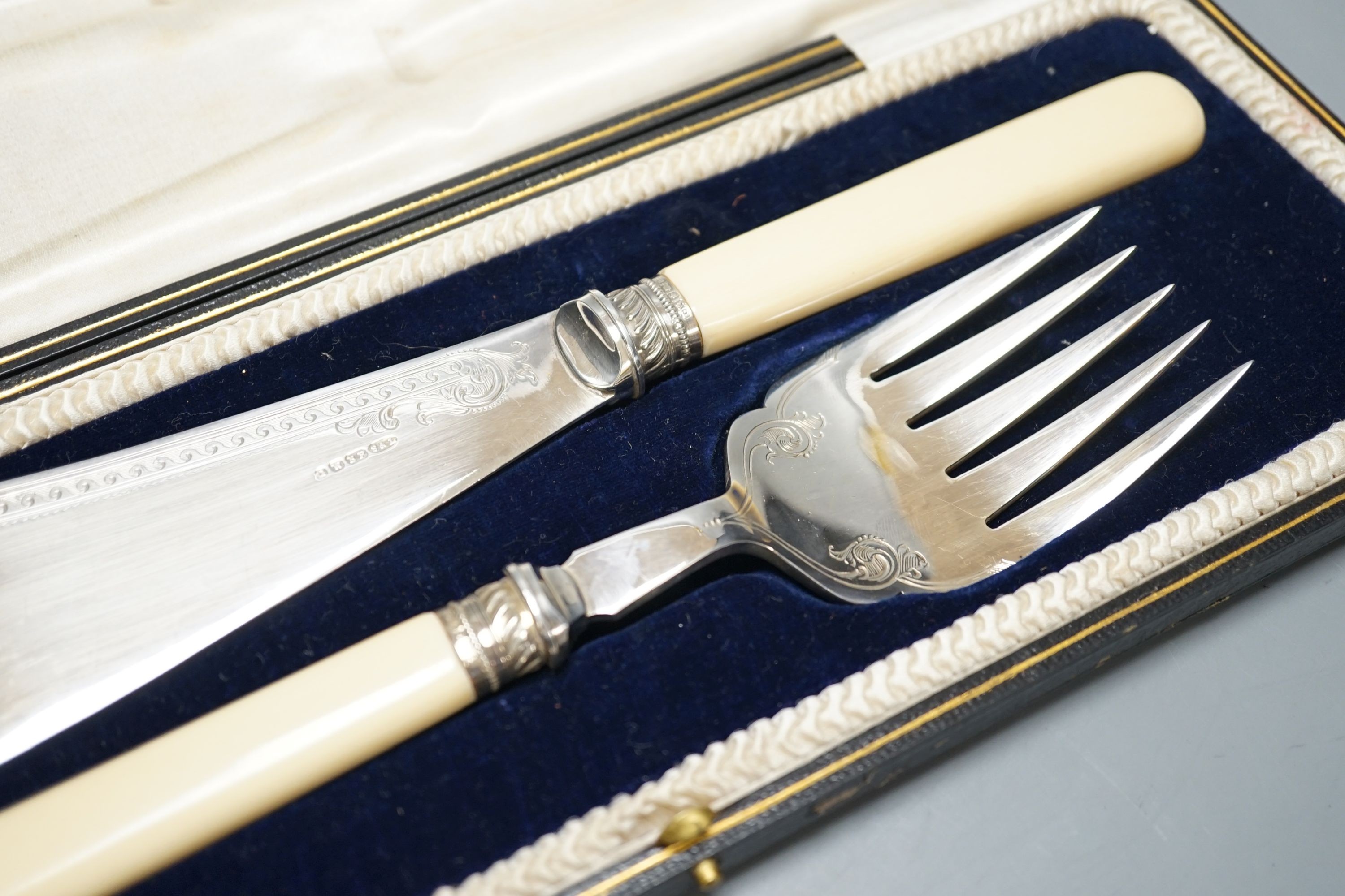 A cased pair of ivory handled silver plated fish servers.